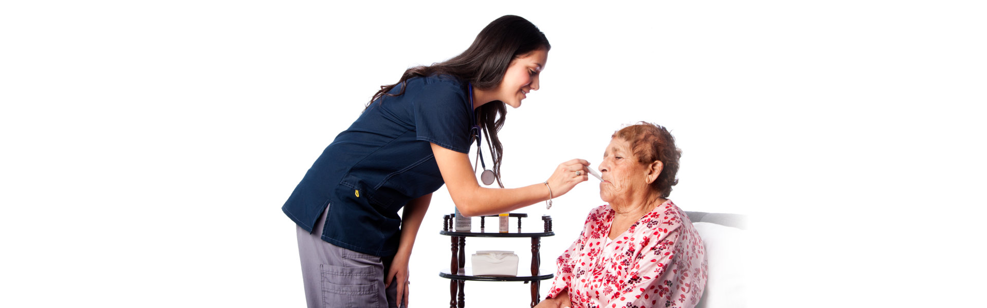 Nurse measuring temperature of senior woman